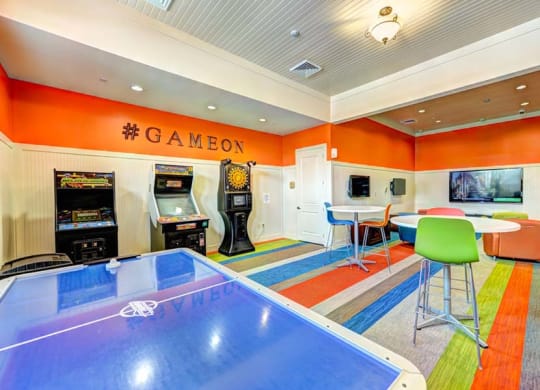 a game room with a ping pong table and arcade games  at Hacienda Club, Jacksonville, 32256