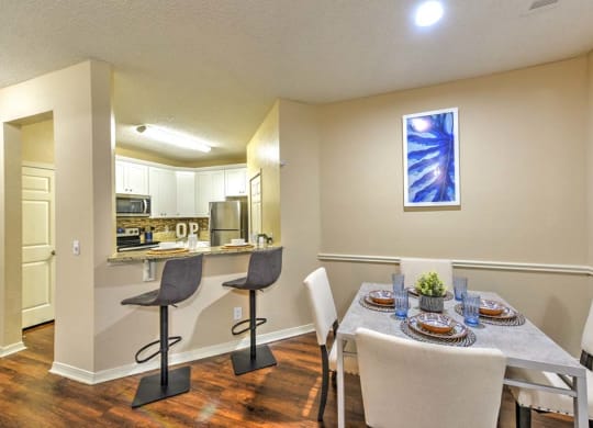 a dining room with a table and chairs next to a kitchen  at Ocean Park, Jacksonville Beach