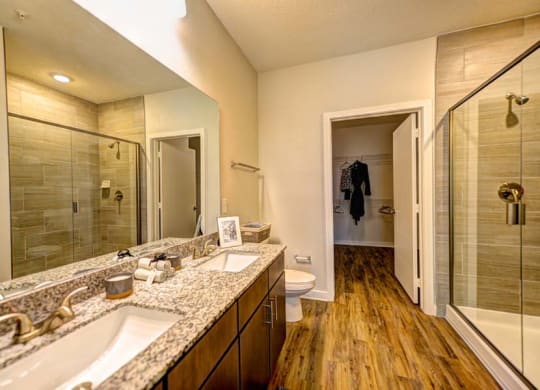 a bathroom with a large mirror and a toilet  at Fusion, Jacksonville, FL, 32256