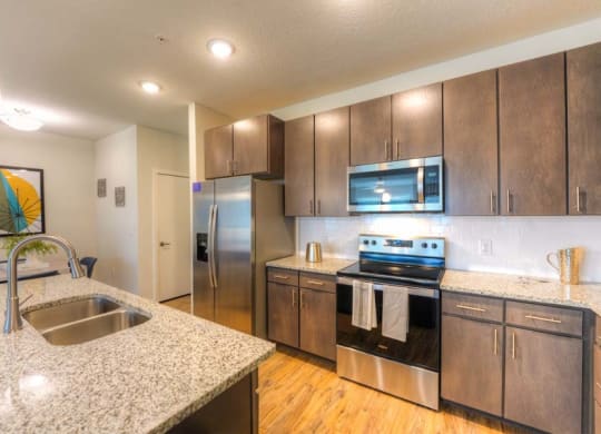 a kitchen with a sink stove and refrigerator  at Fusion, Florida