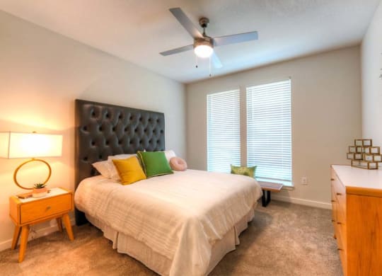 a bedroom with a large bed and a ceiling fan  at Fusion, Jacksonville, 32256