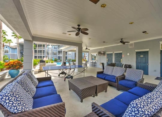 a living room with couches a table and a ping pong table  at Ocean Park, Jacksonville Beach