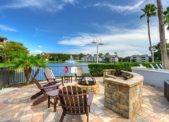 a patio with a fire pit and a lake in the background  at Ocean Park, Florida