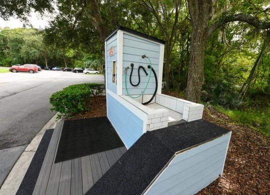 a bench with a hose on it next to a road  at Ocean Park, Jacksonville Beach, FL, 32250