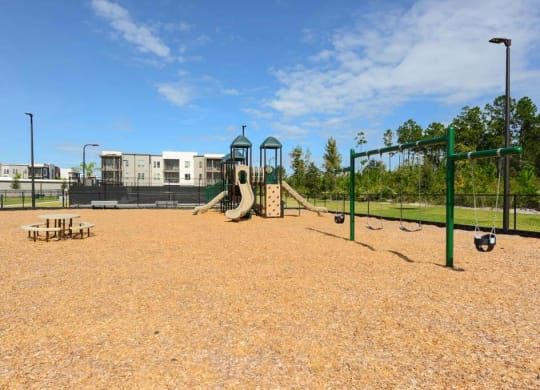 a playground with a slide and monkey bars in front of a building  at Luxor Club, Jacksonville, FL