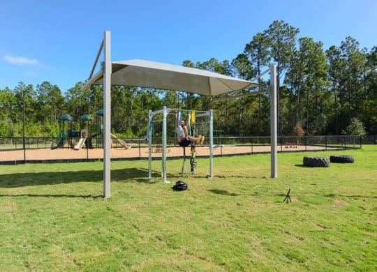 a person on a swing set in a park  at Luxor Club, Jacksonville
