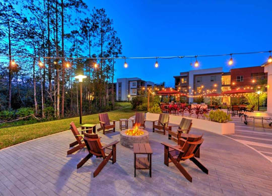 a patio with a fire pit and a lot of chairs  at Luxor Club, Jacksonville, 32258