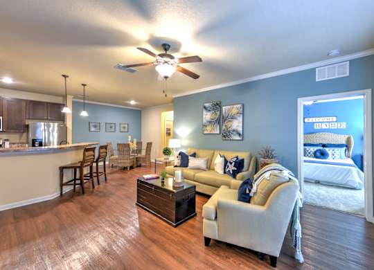 A living room with a couch, chairs, and a coffee table at Cabana Club - Galleria Club Apartments, Florida 32256