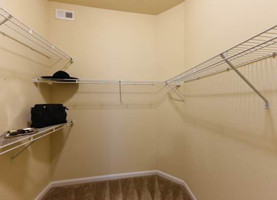 A small closet with a hat on a shelf at Cabana Club - Galleria Club Apartments, Jacksonville, Florida