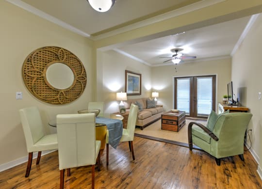 a living room and dining room with a couch and a table at Hacienda Club, Jacksonville, FL, 32256
