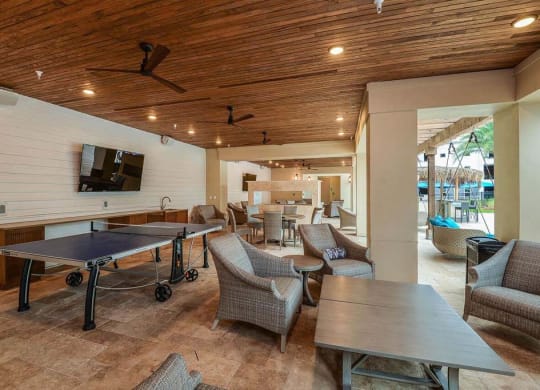 a patio with a ping pong table and chairs  at Palm Bay Club, Jacksonville, Florida