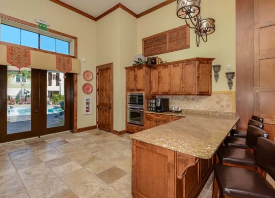 a kitchen with a counter top next to a doorway  at Hacienda Club, Jacksonville, FL, 32256