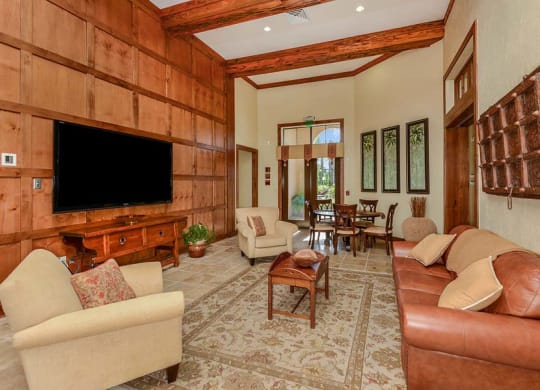 a living room filled with furniture and a flat screen tv  at Hacienda Club, Jacksonville, FL, 32256