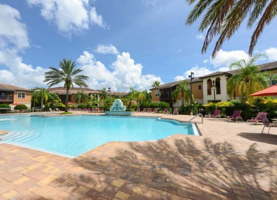 a large swimming pool with a fountain in front of a building  at Hacienda Club, Jacksonville