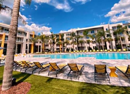 a swimming pool with a bunch of chairs next to it  at Fusion, Jacksonville, FL