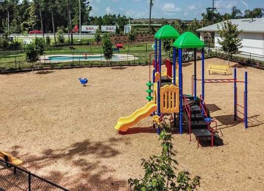 a playground with a slides and a monkey bars  at Palm Bay Club, Florida