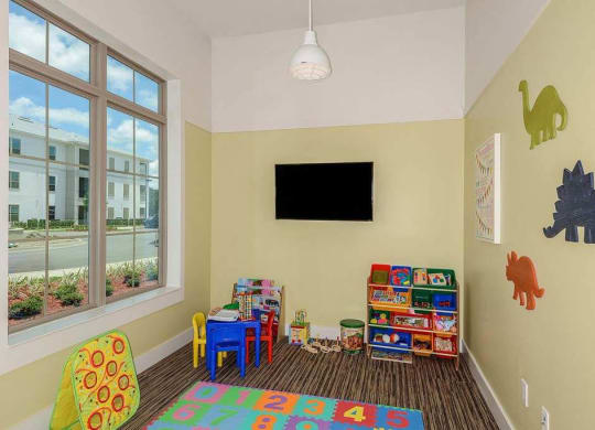 a room with a television and children's toys  at Palm Bay Club, Jacksonville, FL
