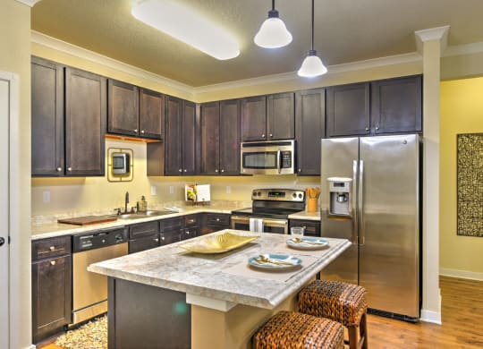 a kitchen with stainless steel appliances and a marble counter top at Hacienda Club, Jacksonville, FL