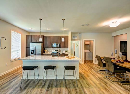 a kitchen with a counter top next to a table  at Luxor Club, Jacksonville, FL, 32258