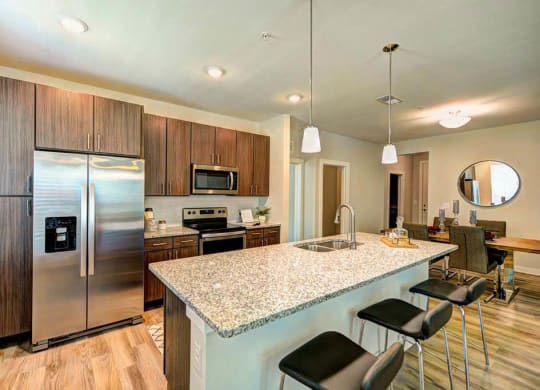 a kitchen with a large counter top next to a refrigerator  at Luxor Club, Jacksonville, FL, 32258