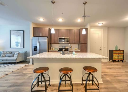 a kitchen with a counter top next to a living room  at Luxor Club, Jacksonville, FL, 32258