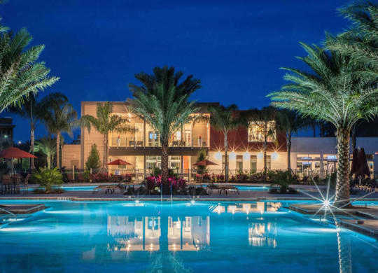 a hotel with a pool in front of it at night  at Luxor Club, Jacksonville, FL, 32258