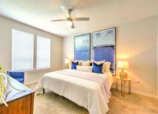 a bedroom with a bed and a ceiling fan  at Luxor Club, Jacksonville
