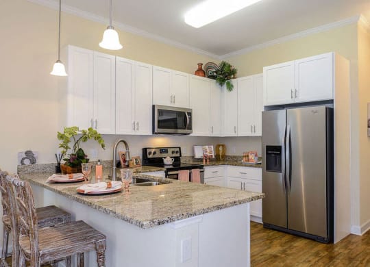 a kitchen with white cabinets and a granite counter top  at Palm Bay Club, Jacksonville, 32258