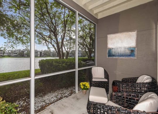 a screened in porch with two chairs and a couch  at Ocean Park, Florida
