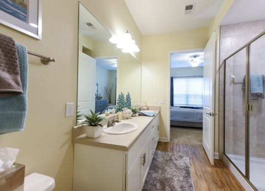 a bathroom with a large mirror and a walk in showerat Palm Bay Club, Florida, 32258