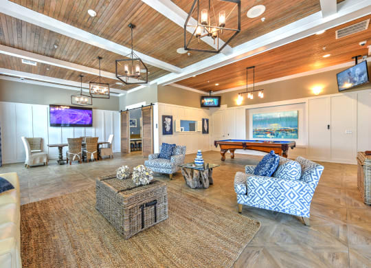 a resident clubhouse with a pool table and flat screen tvsat Palm Bay Club, Jacksonville, FL
