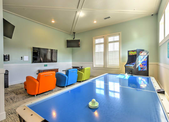 a games room with a ping pong table and a video gameat Palm Bay Club, Jacksonville, Florida