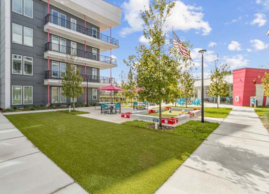 A sunny day at a modern apartment complex with a playgroundat Pinnacle Apartments, Jacksonville, FL