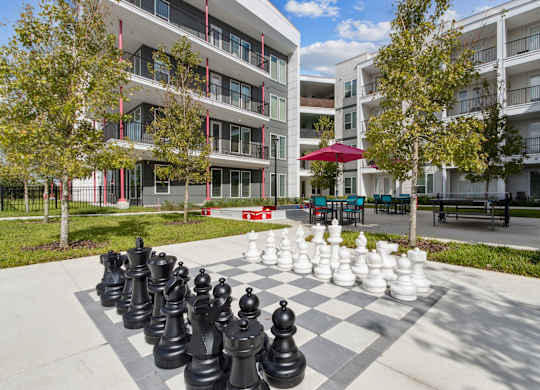 A giant chess set is set up on a sidewalk in front of apartment buildingsat Pinnacle Apartments, Jacksonville, FL