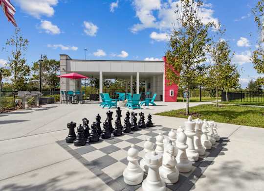 A giant chess set is set up on a concrete surface.at Pinnacle Apartments, Jacksonville, FL