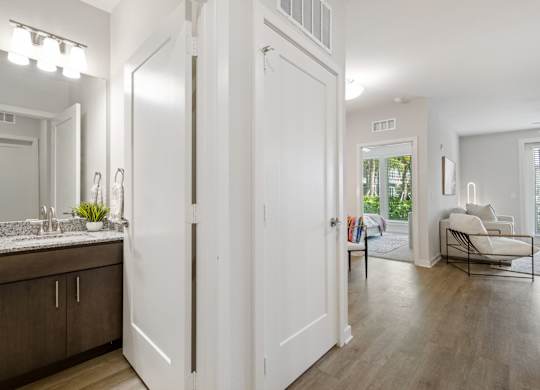 A bathroom with a vanity and a mirrorat Pinnacle Apartments, Jacksonville, FL