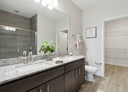 A bathroom with a marble countertop and a walk-in showerat Pinnacle Apartments, Jacksonville, FL