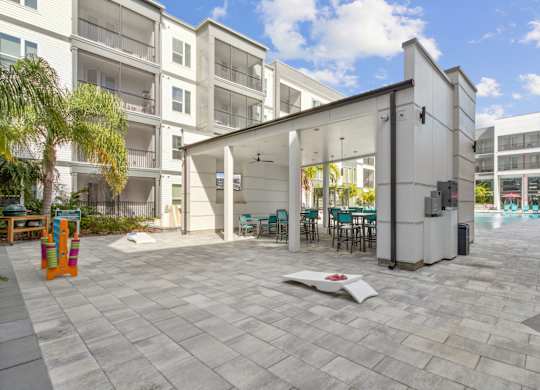 A white building with a patio area in front at Pinnacle Apartments, Jacksonville, FL