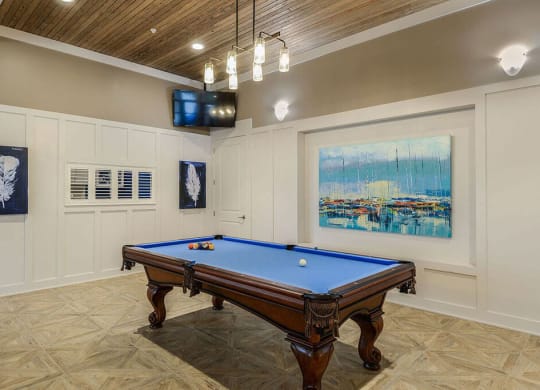 a game room with a pool table and a television  at Palm Bay Club, Jacksonville
