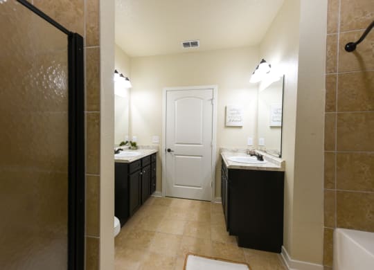 a bathroom with a shower sink and toilet and a sink and a mirror at Hacienda Club, Florida