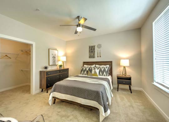 a bedroom with a bed and a ceiling fan  at Luxor Club, Jacksonville, 32258