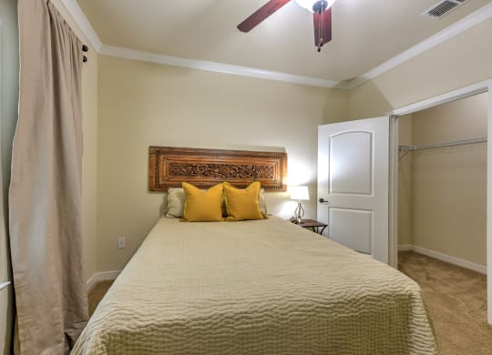 a bedroom with a large bed and a ceiling fan at Hacienda Club, Jacksonville, 32256