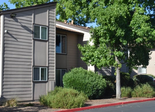 Mutual Housing at Foothill Farms unit exteriors facing trees, shrubs, parking lot