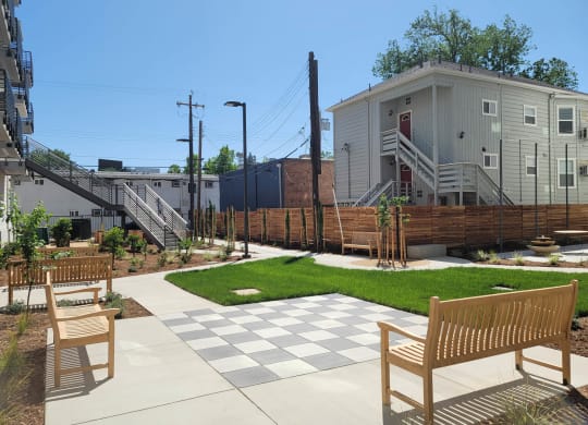 Courtyard and checkerboard area with park benches in interior courtyard.