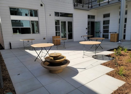 Seating / picnic area with tables and chairs and small fountain.