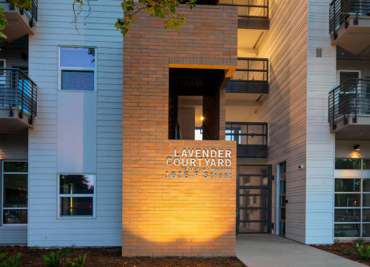 Main entrance of Lavender with brick facade and gated entry door.