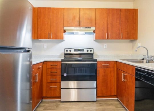 a kitchen with stainless steel appliances and wooden cabinets