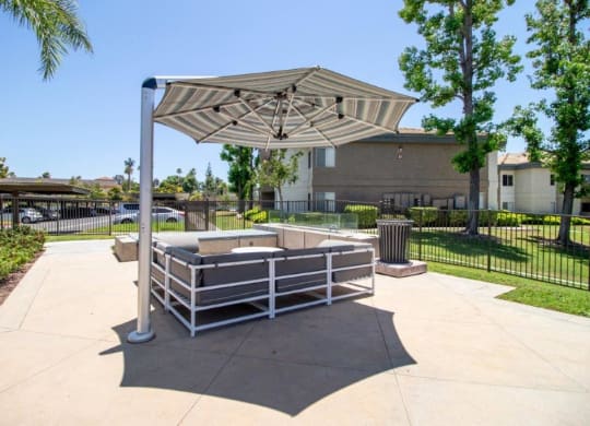 a fenced in area with a picnic table and an umbrella