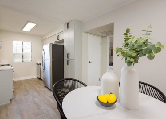 a kitchen and dining room with a table and a refrigerator