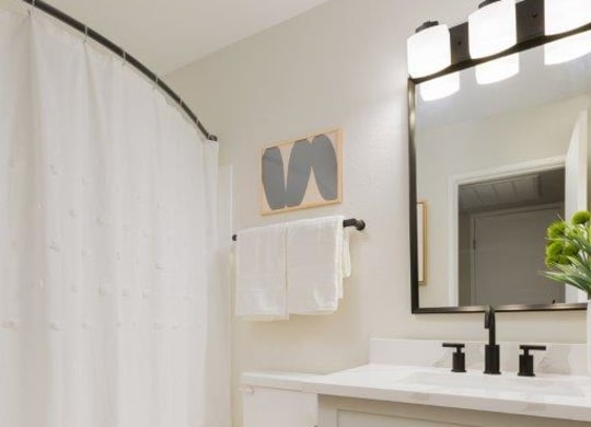 a bathroom with a toilet and a sink and a mirror